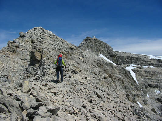 It's better to tackle the summit ridge directly than to traverse below the crest on the snow at right.