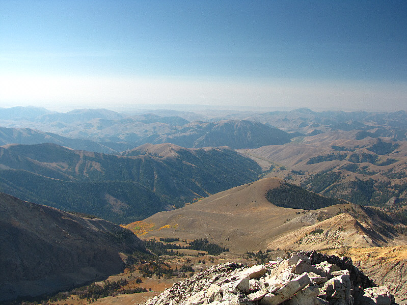 The trailhead is somewhere behind the bald hill just right of centre.