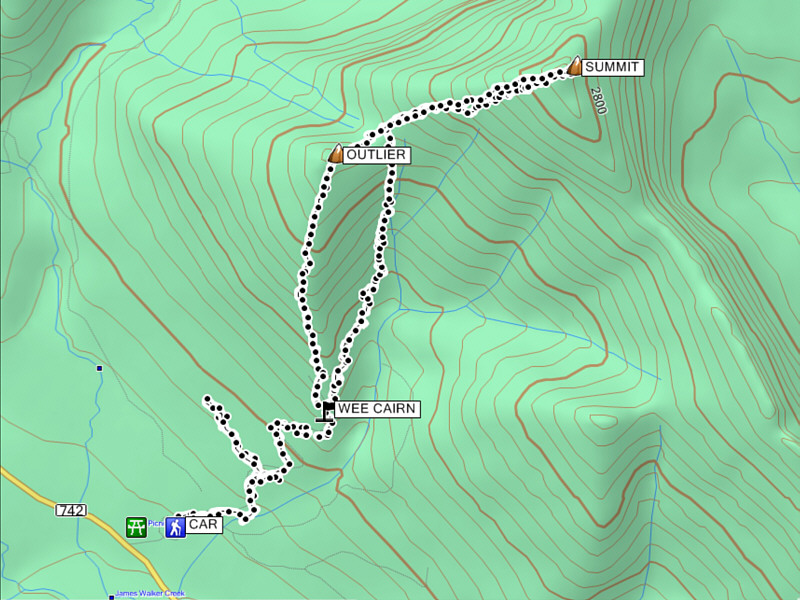 The summit has better views, but the outlier has better scrambling/hiking.