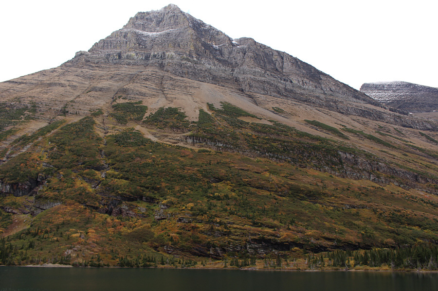 There is actually a moose that is visible on the far side of the lake.