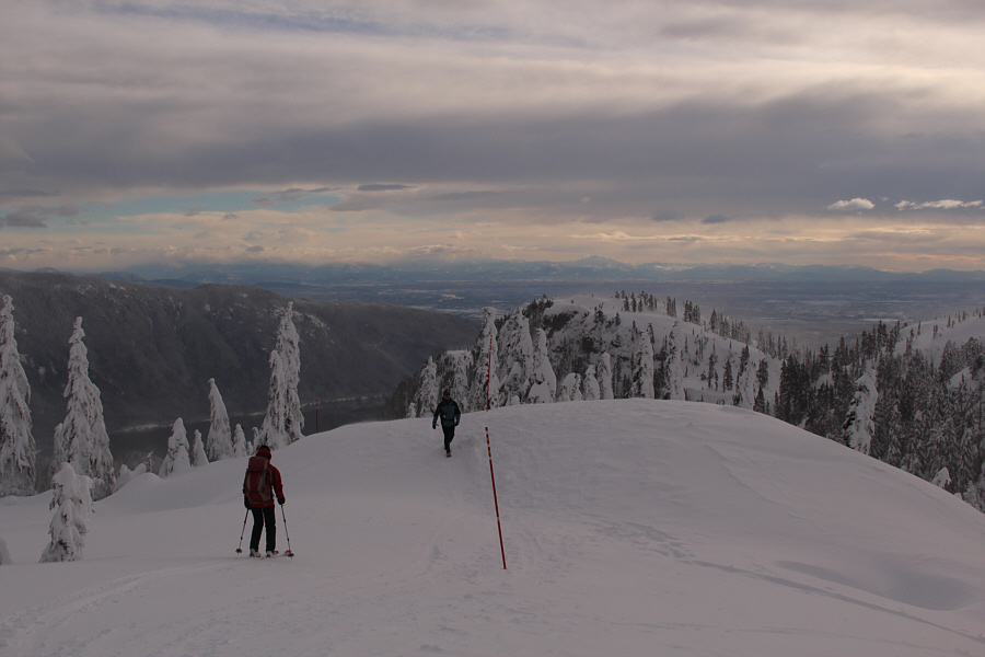 Mount Baker is mostly obscured by clouds just left of centre on the horizon.