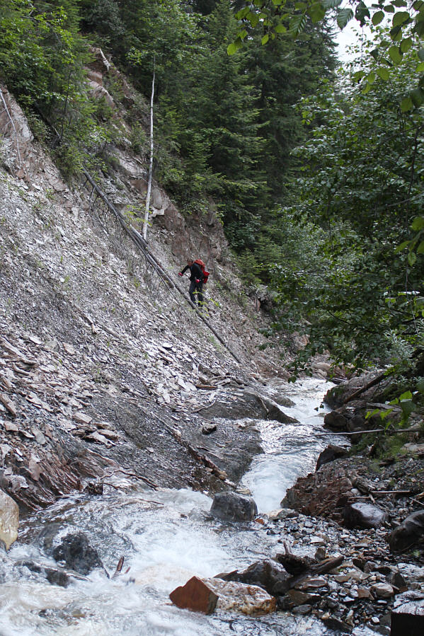 Might be easier to just get your feet wet and trudge in the creek!