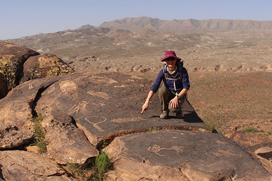 What she is pointing at looks like a maze...or a map! Maybe a treasure map!