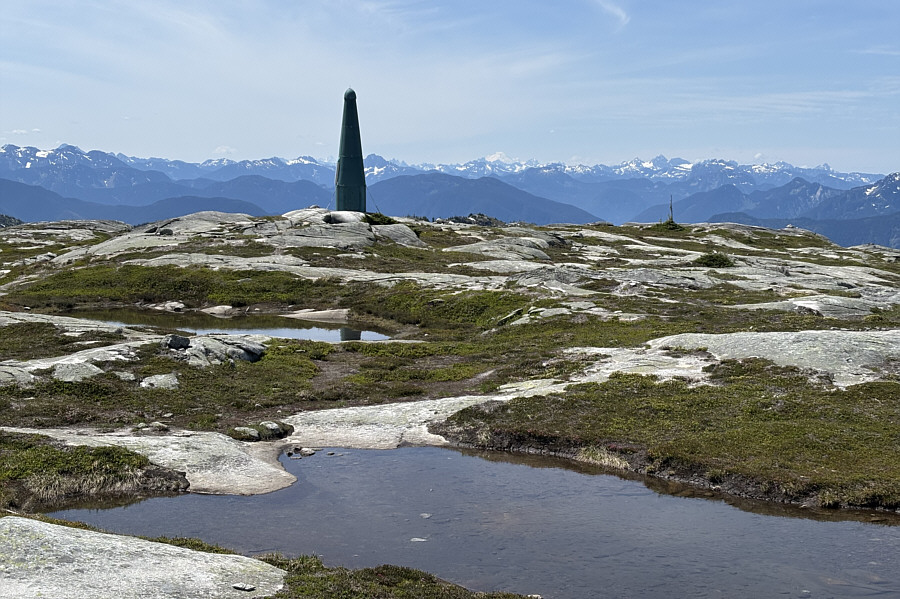 Though the green rocket is shown on a higher contour line on some maps, it's actually lower than the true summit.